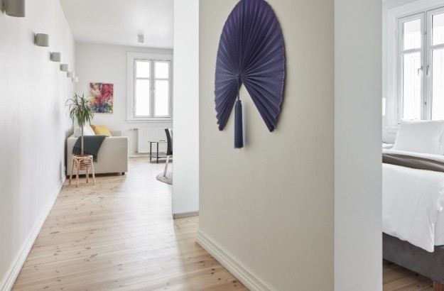 Interior view showing hallway, bedroom and living space with wall art in the superior apartment at Thingholt apartments from Center Hotels in Reykjavik.