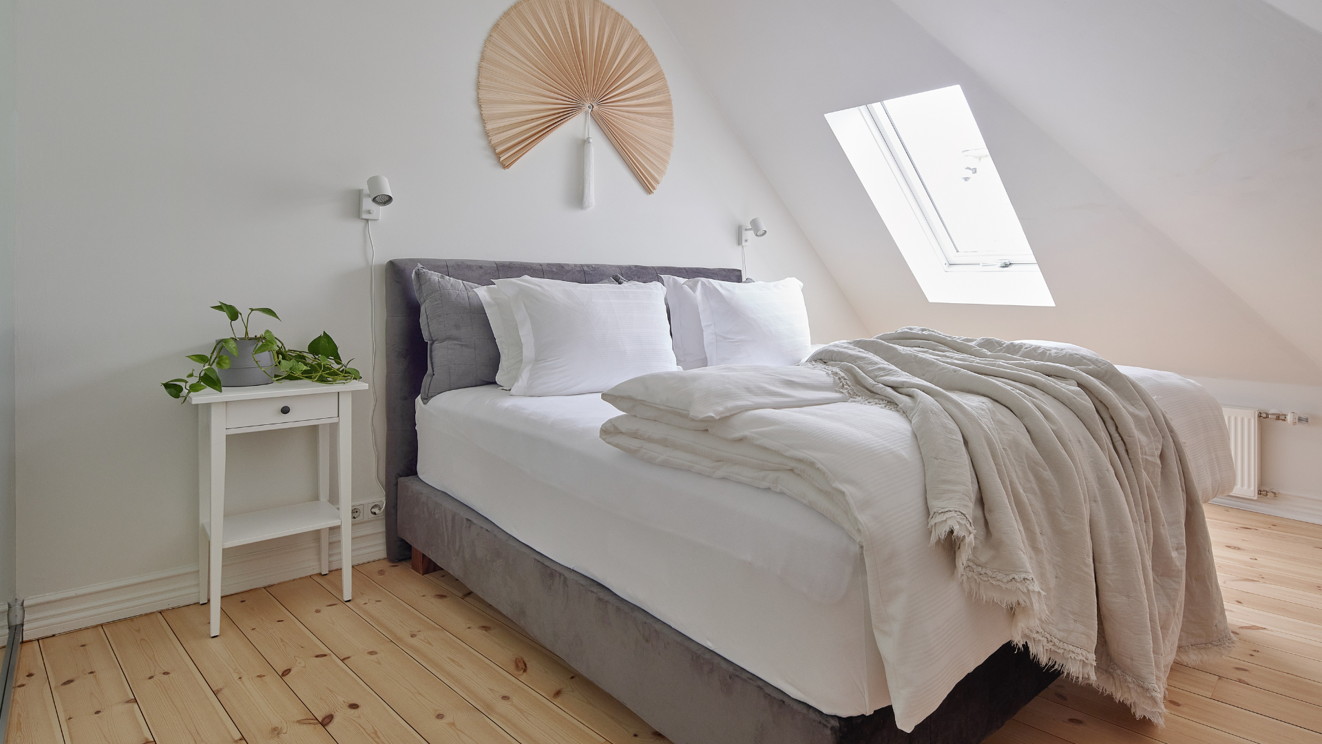 Bright superior apartment bedroom area with skylight and cozy bedding at Thingholt apartments from Center Hotels in Reykjavik.