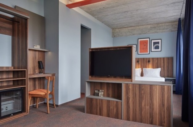 Junior suite at Grandi by Center Hotels in Reykjavik featuring open-plan layour with bed, desk, and TV divider.