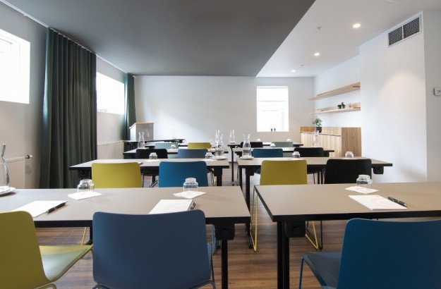 Conference desks and chairs arranged in As meeting room at Midgardur by Center Hotels in Reykjavik.