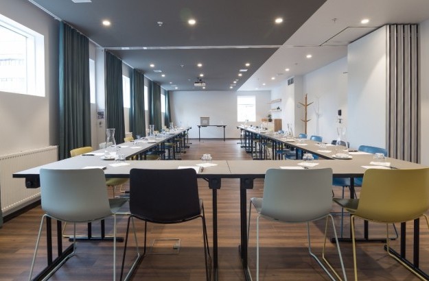 Asgardur meeting room at Midgardur by Center Hotels in Reykjavik arranged in a u-shape with natural light.