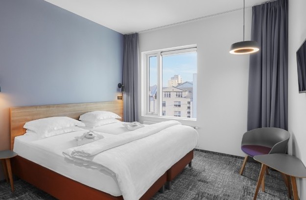 Spacious standard plus room at Midgardur by Center Hotels in Reykjavik with a double bed, window, and modern decor.