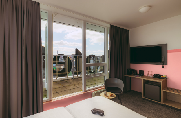 A picture of the executive room at Center Hotels Plaza showing the overlook of the room and focusing on the large balcony overlooking the city center of Reykjavík.