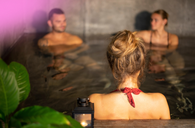 Guests relaxing in the hot tub at Miðgarður Spa