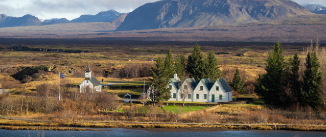 Þingvellir national park in the winter time. The church and houses in Þingvellir visible as well as the mountain range behind.