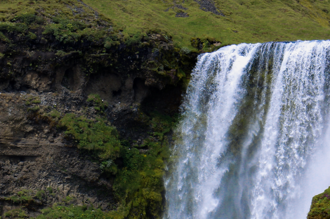 A large waterfall in with powerful water stream in the summer time in the south coast of Icelanc