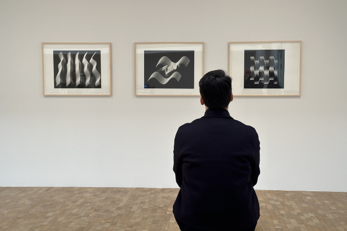 Visitor viewing black and white modern art photography in a Reykjavík gallery