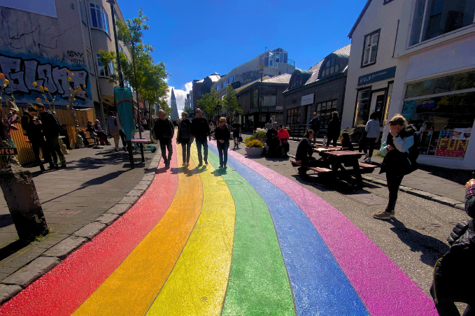 People walking along the rainbow-painted Skólavörðustígur street in central Reykjavík