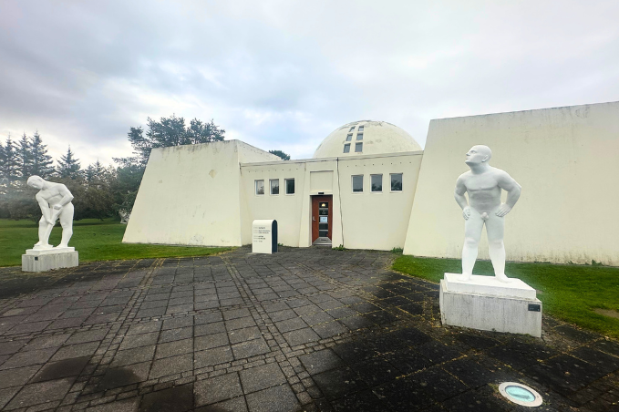 Exterior of Ásmundarsafn sculpture museum with outdoor sculptures in Reykjavík, Iceland
