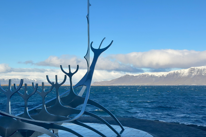 Sun Voyager sculpture by the sea in Reykjavík with Mount Esja in the background.