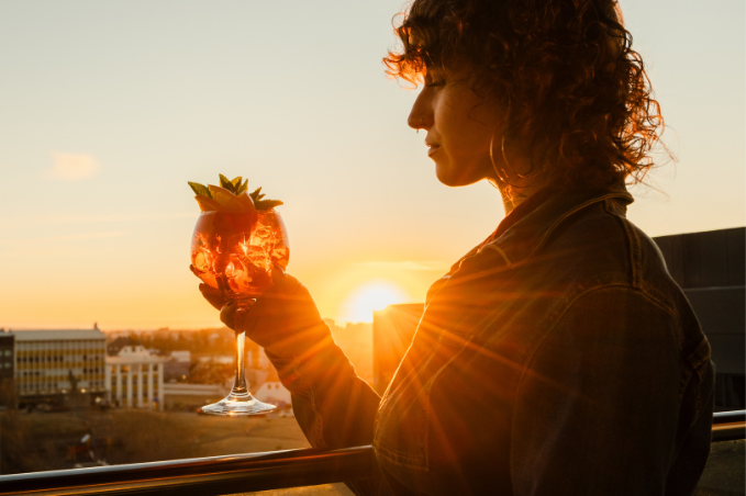 Guest enjoying a cocktail at sunset at SKY Lounge and Bar in Reykjavik
