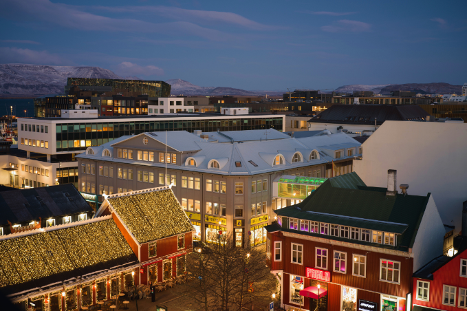 Reykjavík city center illuminated with Christmas lights during a winter evening.