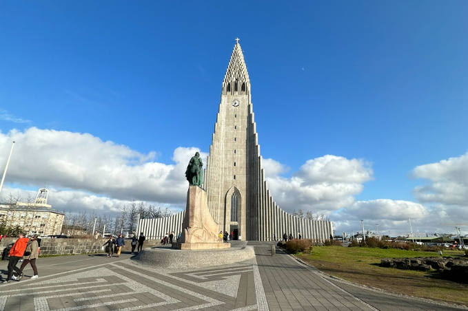 Hallgrimskirkja church towering over Reykjavik with a statue of Leif Eirikson in front.