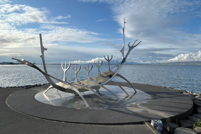 The Sun Voyager steel sculpture shaped like a Viking ship beside the ocean in Reykjavik.