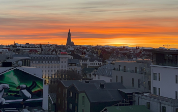 View of Reykjavik Iceland at sunset with Hallgrimskirkja church, colorful rooftops, and city skyline from above