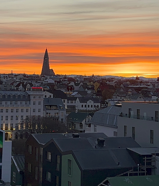 View of Reykjavik Iceland at sunset with Hallgrimskirkja church, colorful rooftops, and city skyline from above