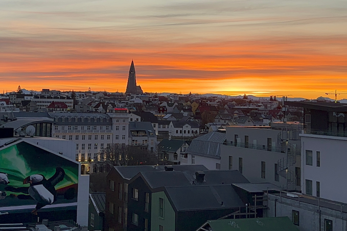 View of Reykjavik Iceland at sunset with Hallgrimskirkja church, colorful rooftops, and city skyline from above
