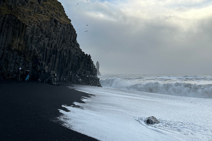 Reynisfjara black sand beach with basalt cliffs and waves on Iceland's South Coast