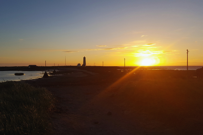 Sunset over the coast at Grótta Lighthouse in Reykjavík.