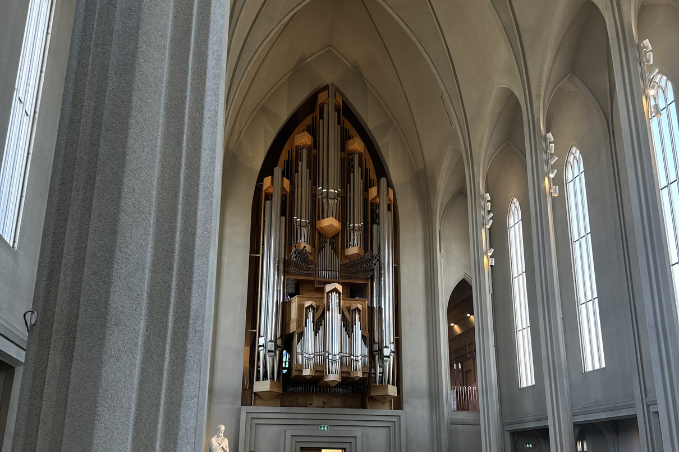 Interior of Hallgrímskirkja featuring the iconic pipe organ and soaring Gothic-inspired architecture.