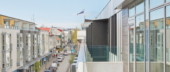 laugavegur street in reykjavik, seen from center hotels laugavegur showing the icelandic flag, street, houses and cars from the third floor