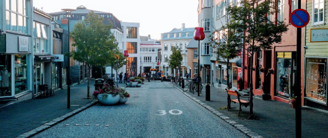 laugavegur street in reykjavik including a few houses, signs and trees