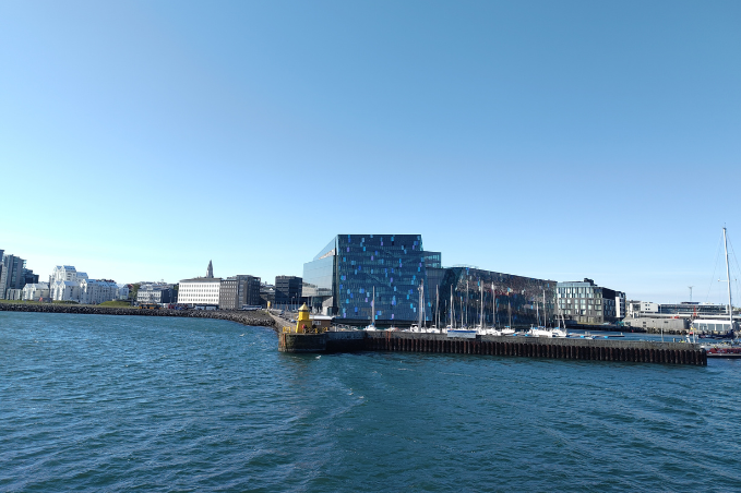 Harpa Concert Hall and Reykjavík waterfront seen from the harbor on a sunny day