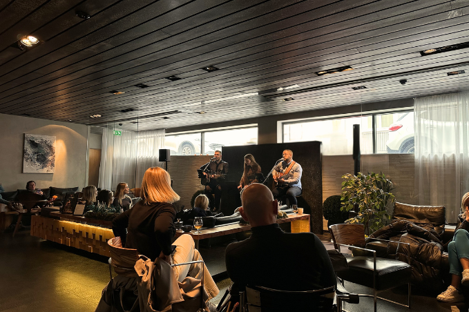 Audience watching an intimate live concert performance inside a stylish Reykjavík lounge bar