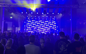 Crowd enjoying a live music concert with colorful stage lighting at a popular nightlife venue in Reykjavík, Iceland