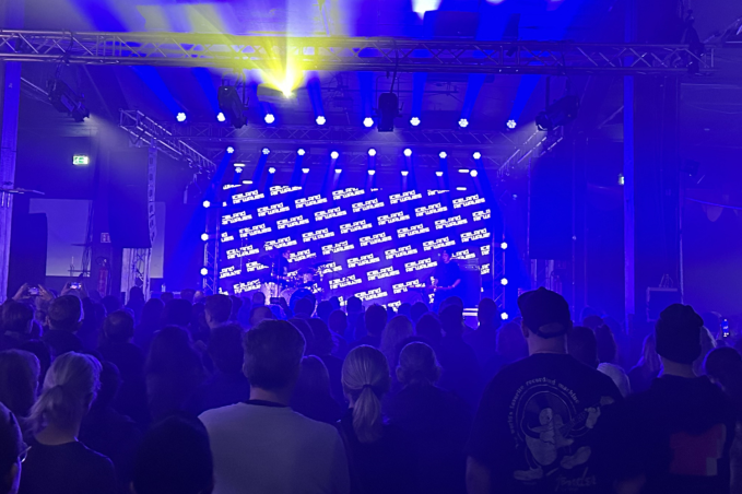 Crowd enjoying a live music concert with colorful stage lighting at a popular nightlife venue in Reykjavík, Iceland