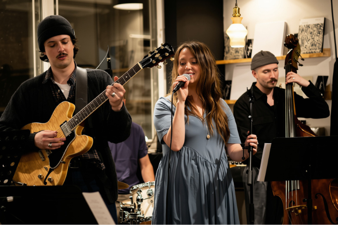 Live band performing in Reykjavík with a singer, guitarist and double bass player.