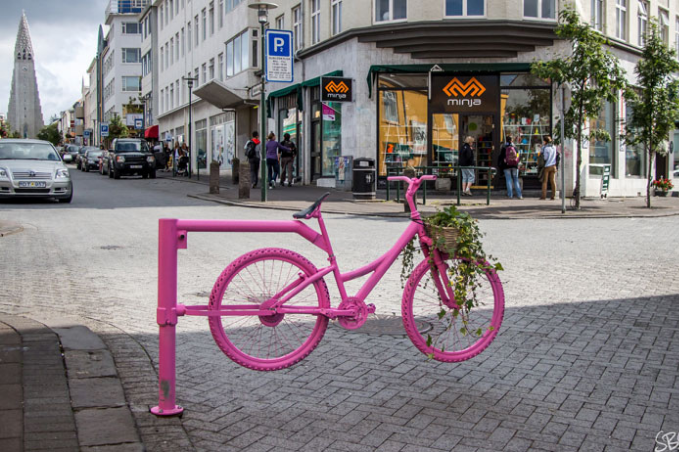 Street view over Bankastræti with a pink bicycle in front closing the street for cars
