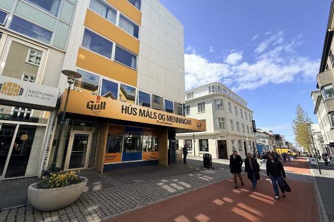 Pedestrian street in downtown Reykjavík with shops, museums and local visitors walking by