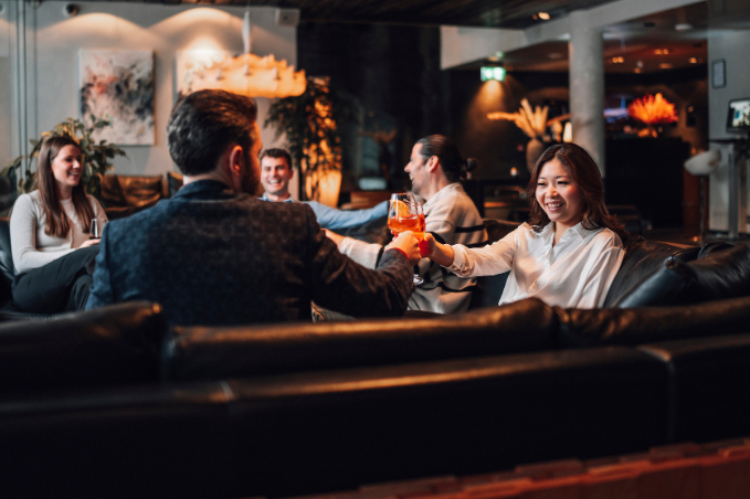 Guests enjoying cocktails and conversation in a stylish Reykjavík hotel lounge