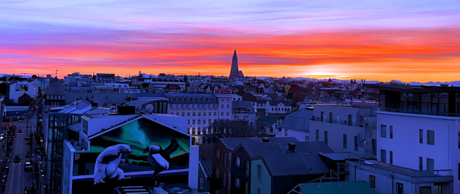 Colorful winter sunset over downtown Reykjavík with Hallgrímskirkja in the distance.