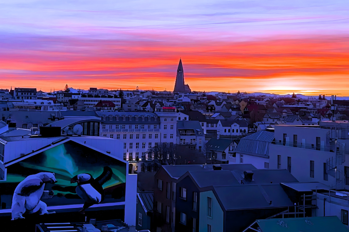 Colorful winter sunset over downtown Reykjavík with Hallgrímskirkja in the distance.