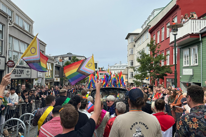 Crowds waving rainbow flags during the Reykjavík Pride parade.