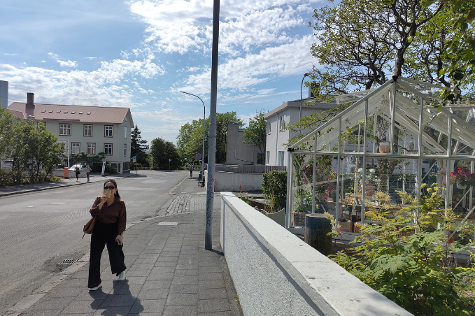 Visitor strolling along a sunny street in Reykjavík.
