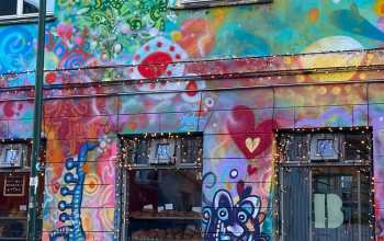 Brauð & Co bakery in Reykjavík, with vibrant murals of hearts, swirls and playful figures covering its façade.