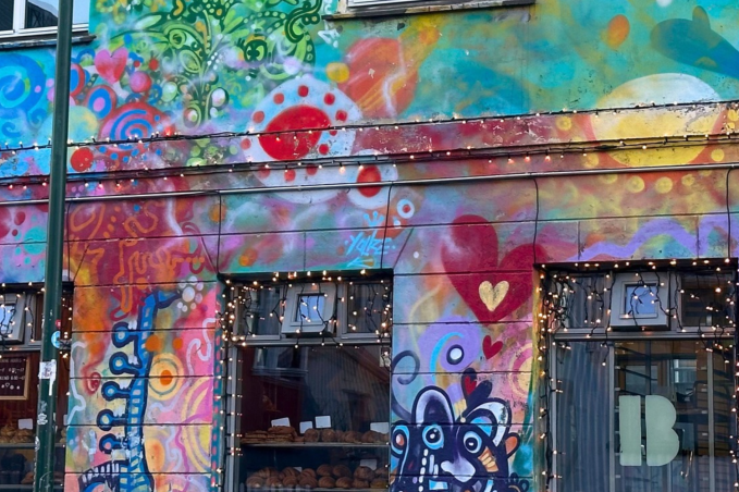 Brauð & Co bakery in Reykjavík, with vibrant murals of hearts, swirls and playful figures covering its façade.