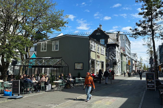 Laugavegur shopping street in downtown Reykjavík with cafés, colorful buildings and pedestrians.