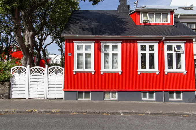 Traditional red corrugated iron house with white windows in Reykjavík